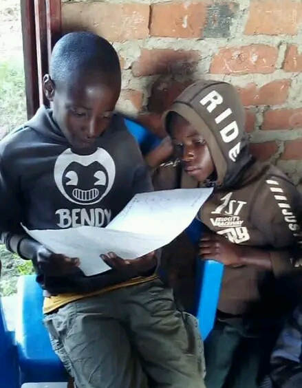 Two students reading at Kisiizi Good Shepherd Orphanage Uganda
